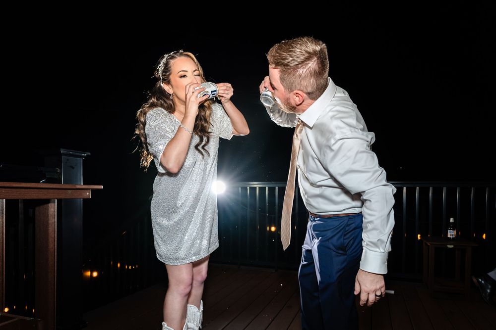 Two children dancing and celebrating at a nighttime outdoor party on a deck.