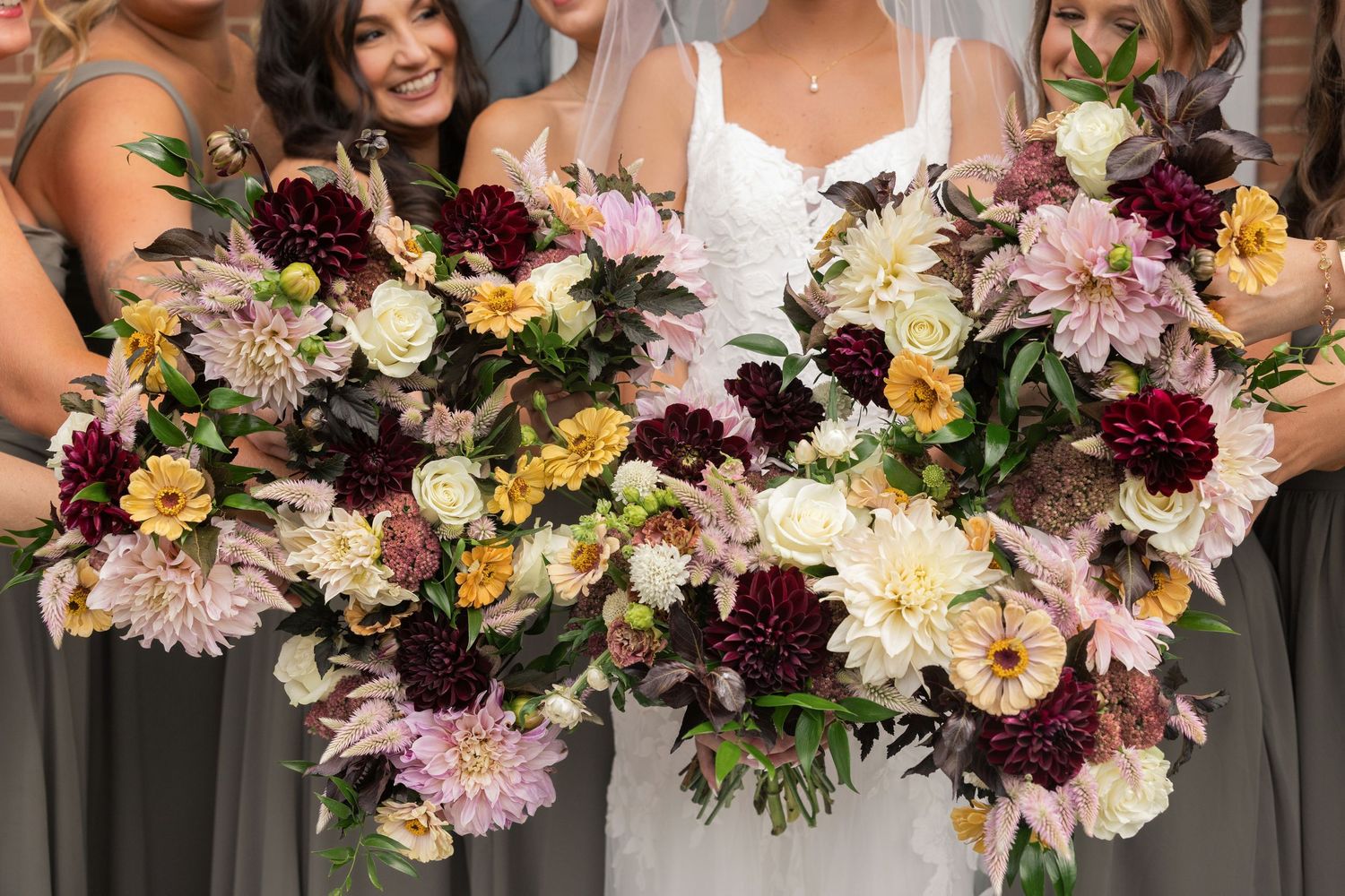 Bridal bouquets with burgundy dahlias, blush, mustard, and ivory blooms at a Little Brook Meadows wedding in Lancaster, Ohio
