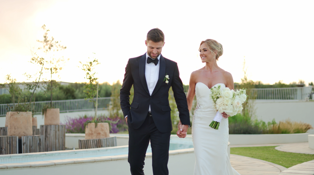 Newlyweds laughing together during their relaxed wedding portrait session.