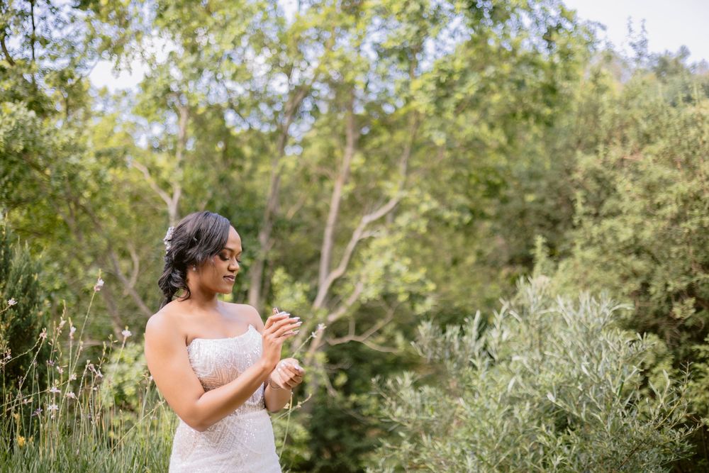 Bride putting on her earrings during wedding preparations.