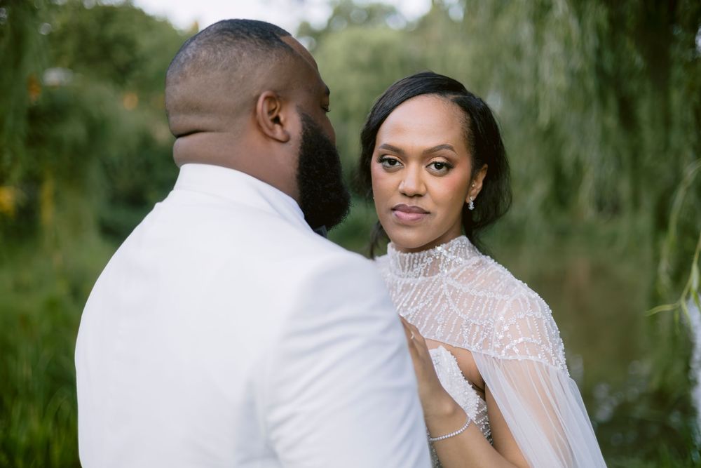 Cinematic wedding portrait of a couple surrounded by natural scenery.