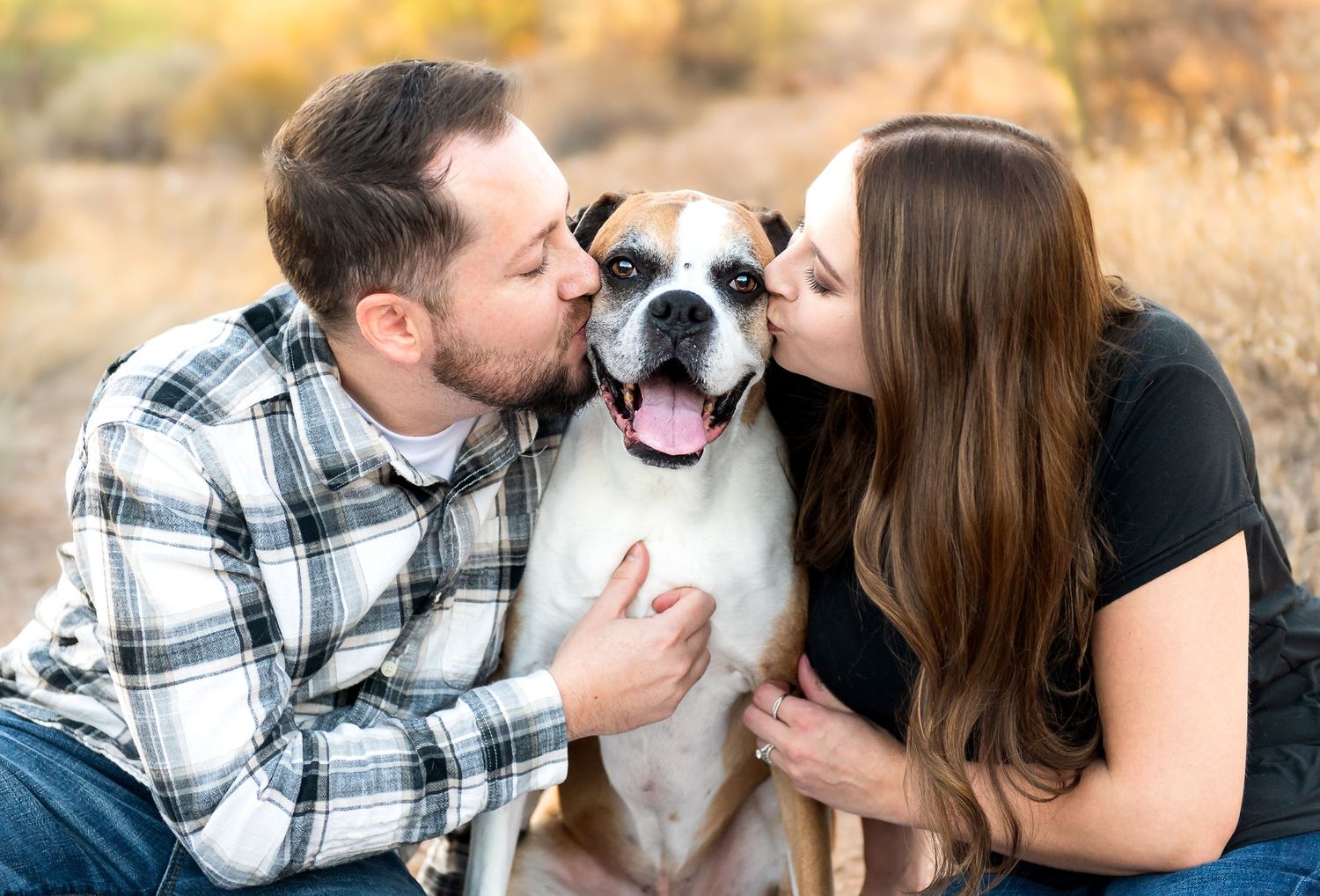 Couple and their dog on vacation in Arizona posing during their family vacation photography session.