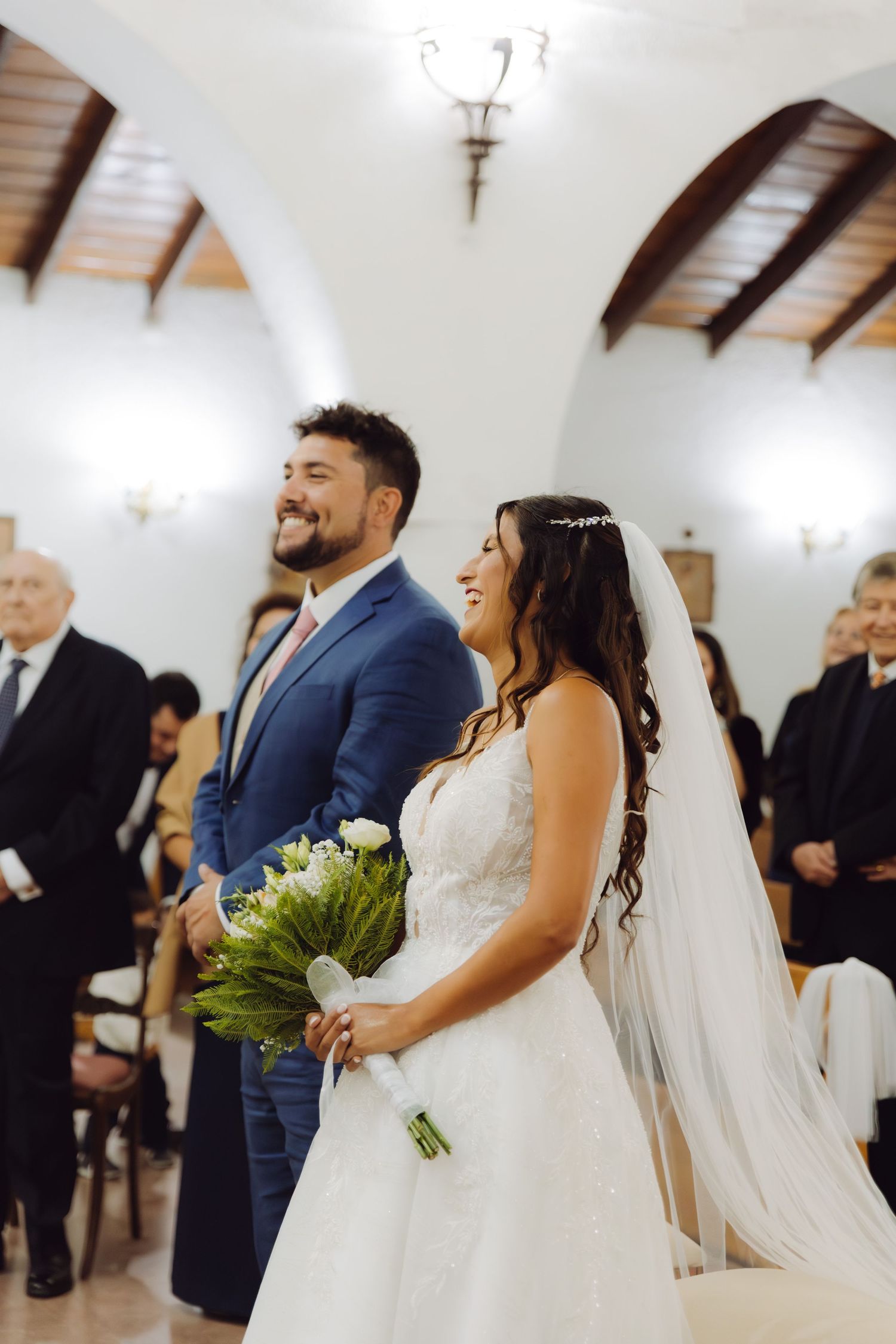 Smiling bride and groom standing together at the altar during their church wedding.