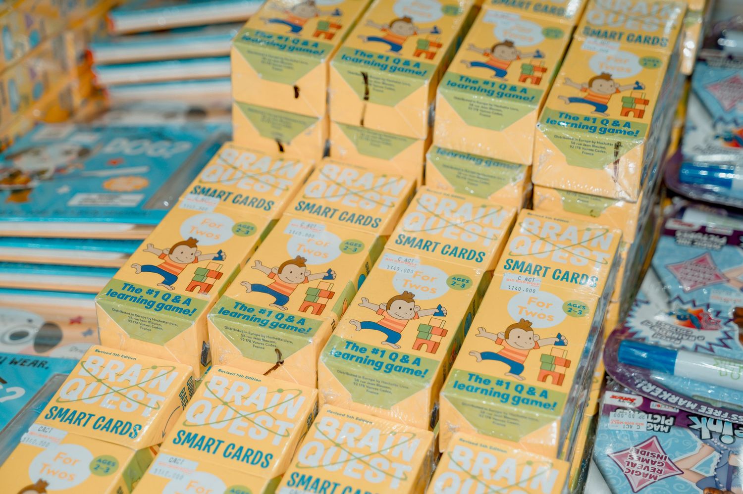 Rows of Smart Cards educational card game boxes displayed at a market stall with colorful packaging.