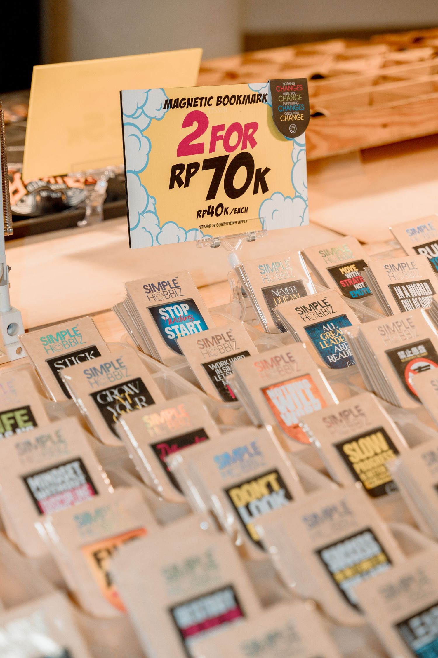 Display of magnetic bookmarks for sale at 2 for RP 70K, featuring various motivational designs in clear packaging.