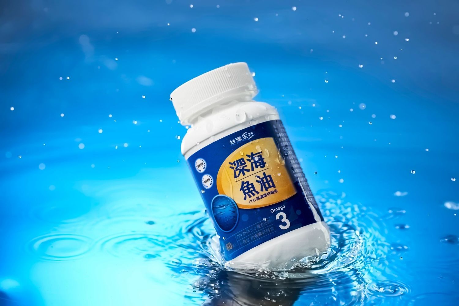 Deep sea fish oil omega-3 supplement bottle floating on blue water with splash effect.