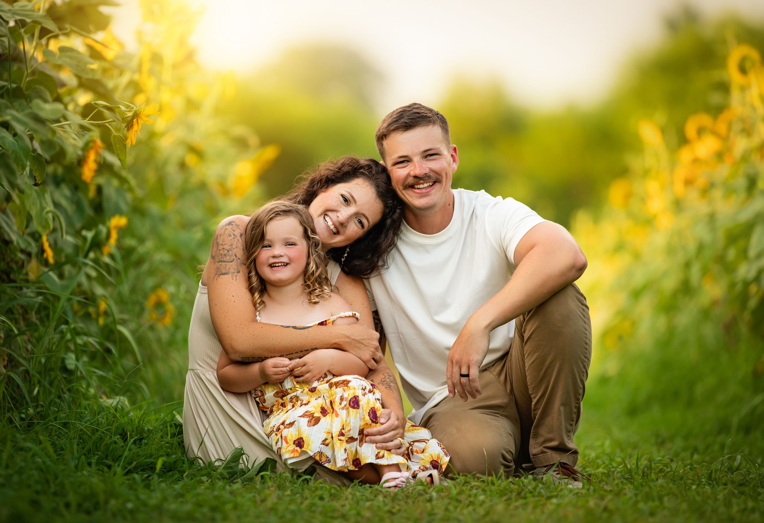 A warm sunset portrait among tall yellow wildflowers in a natural outdoor setting with a picnic basket.