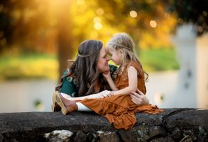 Intimate outdoor portrait moment captured in warm golden sunset light.