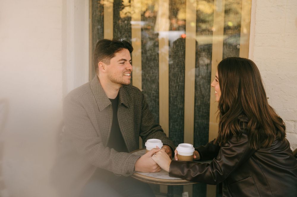 Intimate coffee date at an outdoor cafe table with warm lighting.