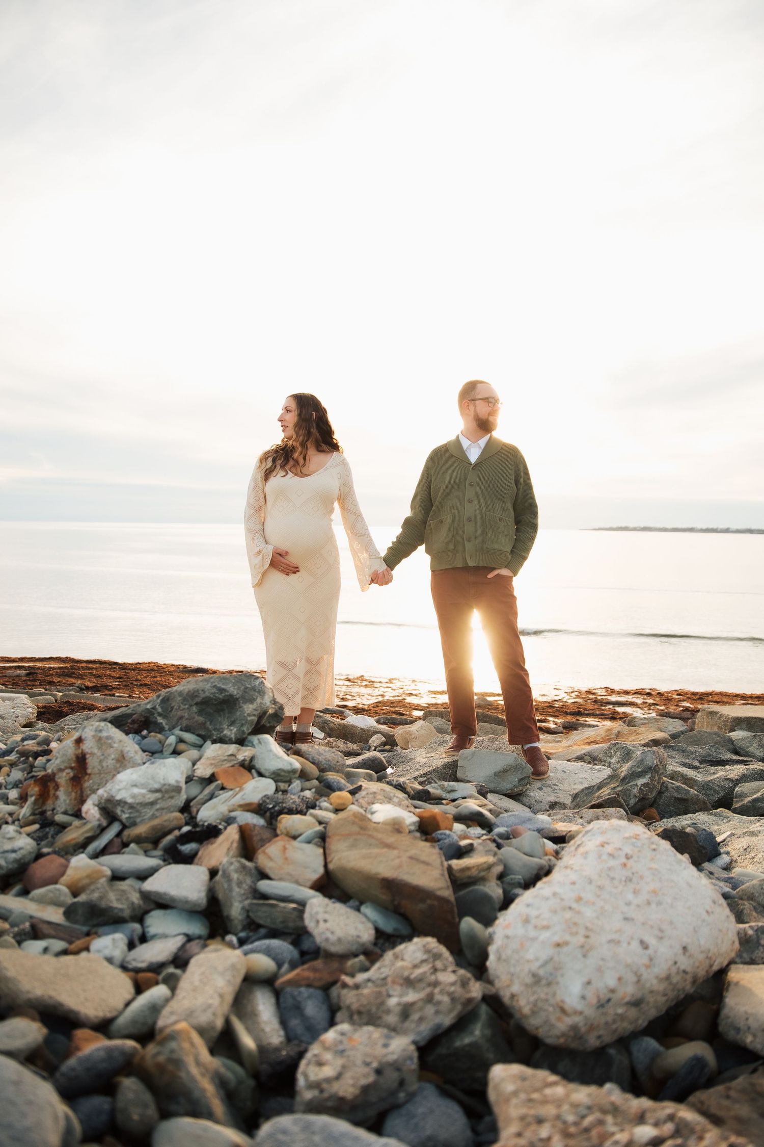 Couplestands on beach during maternity photoshoot. Middletown RI Sachuset Point Second Beach