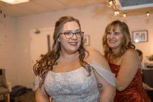 Wedding guests celebrating and dancing during indoor reception party.