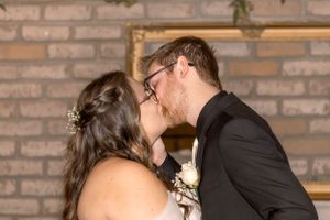 Wedding celebration in rustic venue with exposed brick walls and romantic lighting.