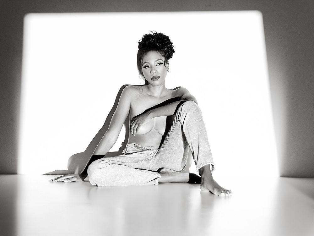 A black and white artistic boudoir photoshoot showing a model in various graceful poses on light backdrop.