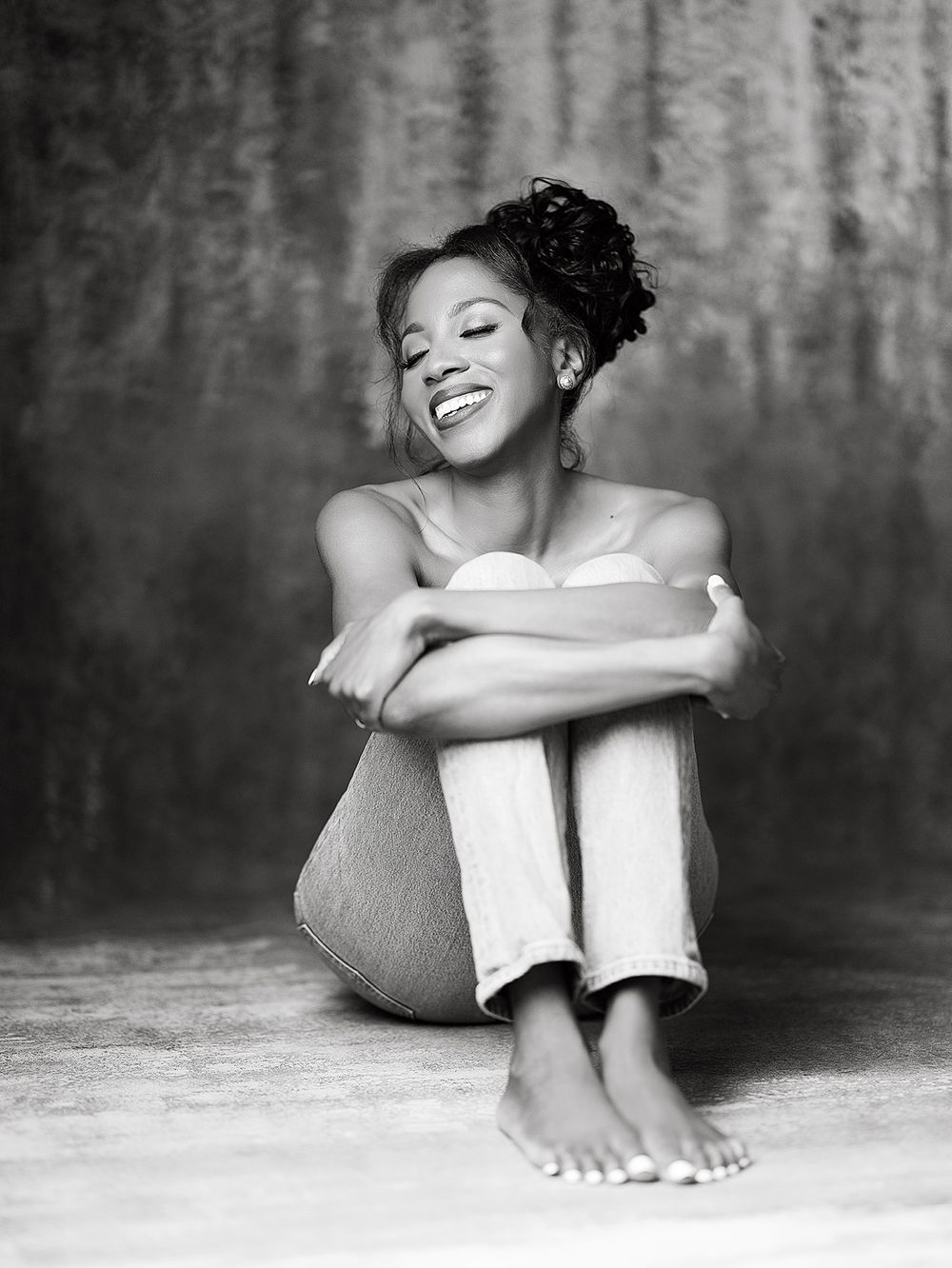 Black and white photographs show different cropped segments of a person reclining and smiling playfully.