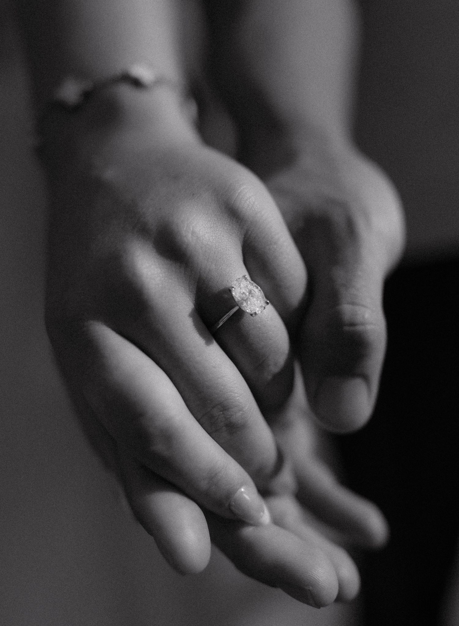 Newlyweds hold up their wedding rings after getting married at the Hidden Willows