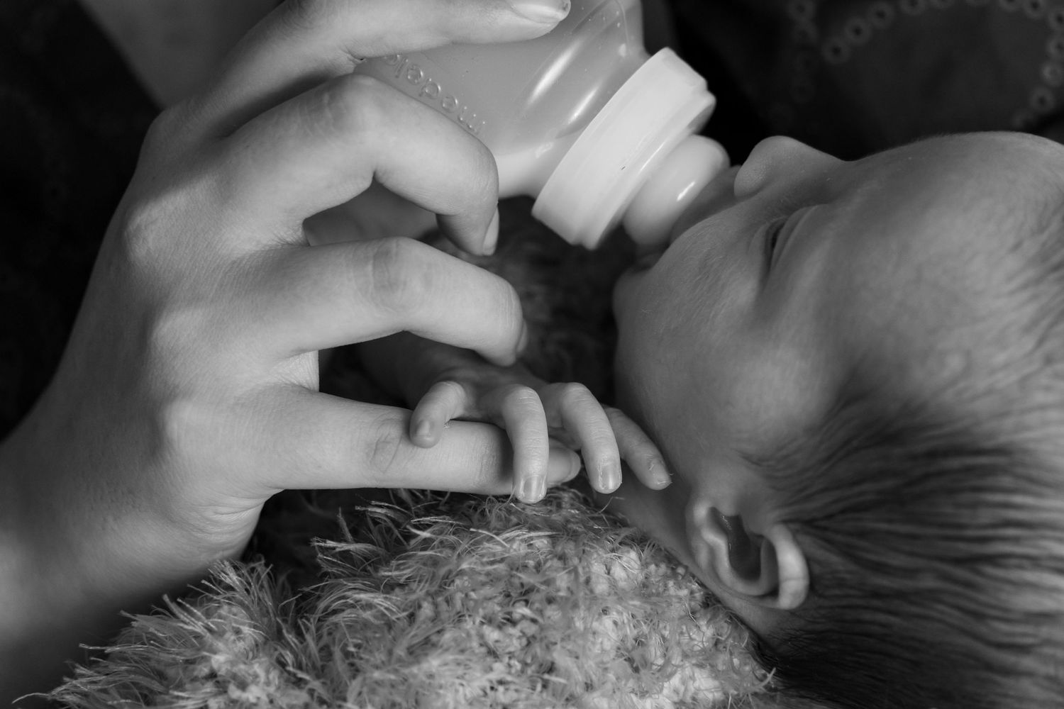 Mother feeding baby a bottle