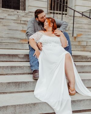 A romantic wedding photoshoot on stone steps with a couple in casual and formal attire sharing an intimate moment.