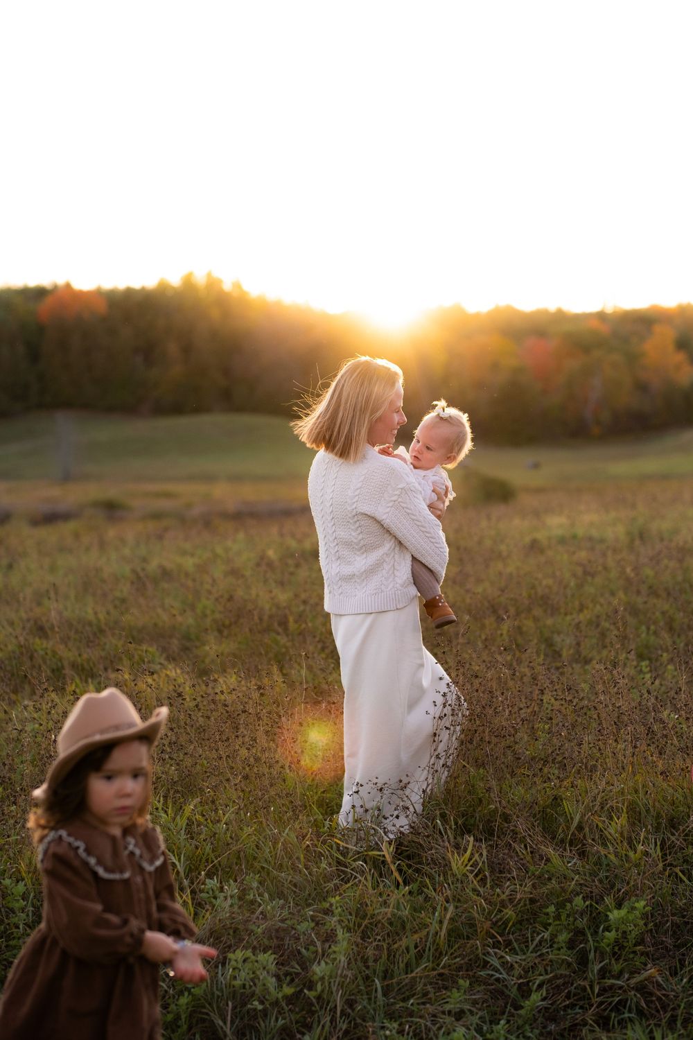 A collection of sunset photos in a field shows silhouettes against golden light and tall grass during golden hour.