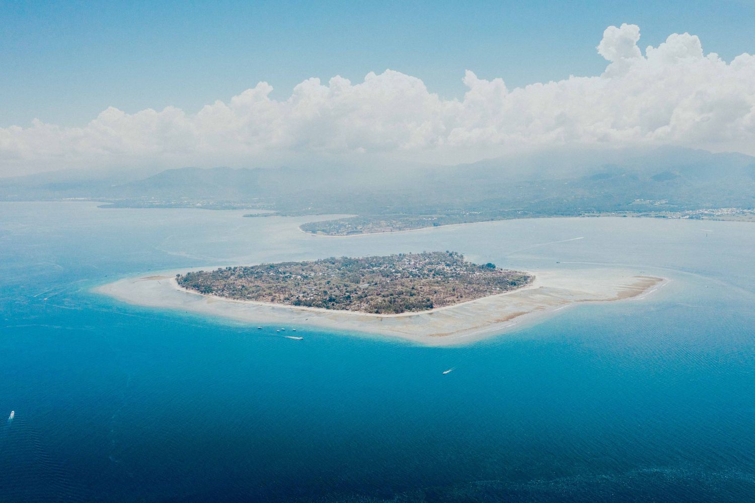 Aerial view of tropical island paradise surrounded by crystal blue waters.