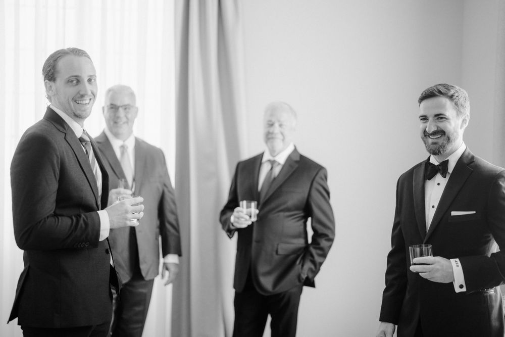 Group of formally dressed people socializing with drinks at an elegant gathering. Photoshoot by Venice Photographer Alina Indi
