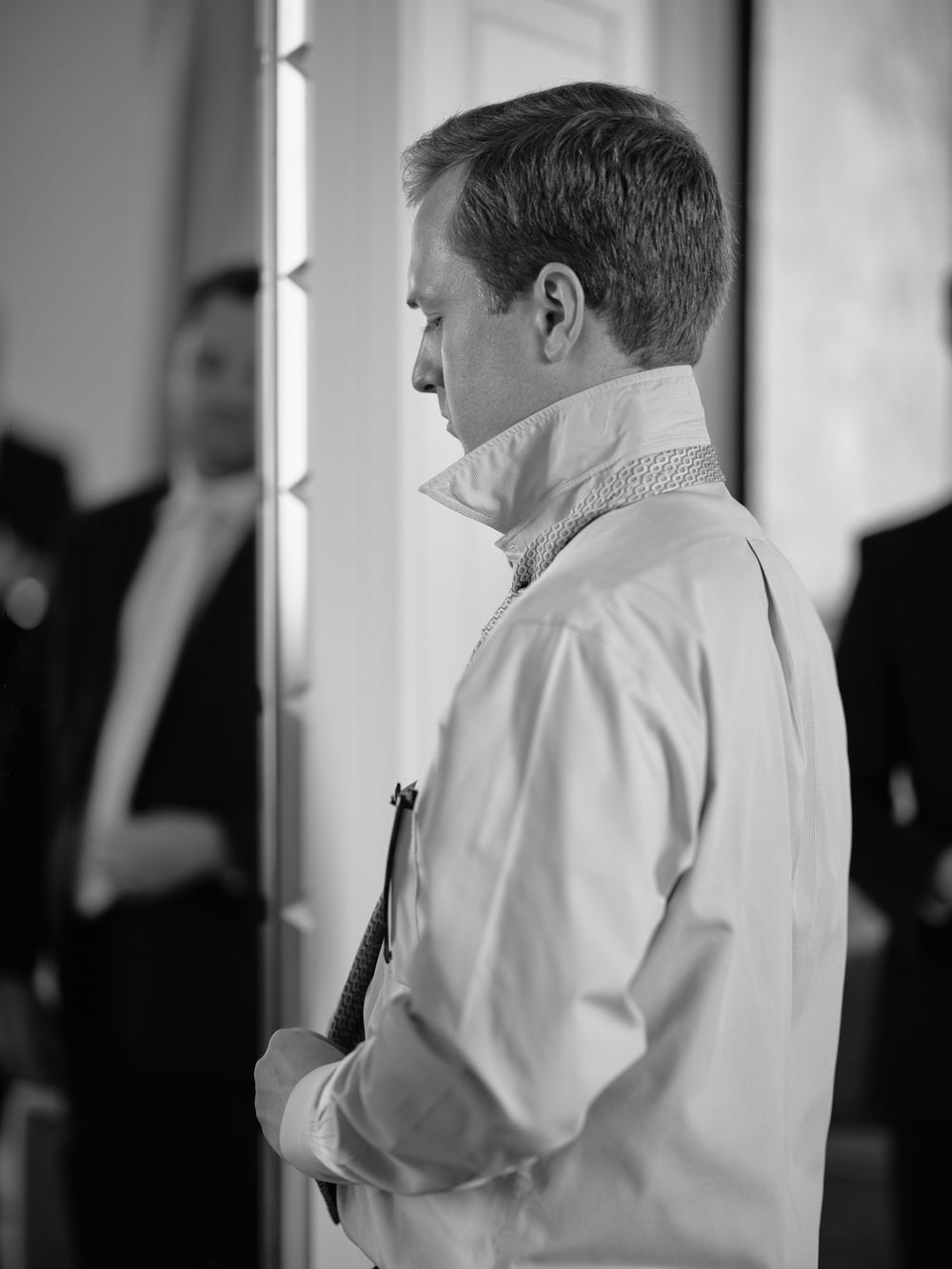 Side profile view of someone adjusting their formal white shirt collar. Photoshoot by Venice Photographer Alina Indi