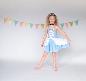 Light blue and white dress with ruffles seen from multiple angles, shown against white background with pastel bunting.