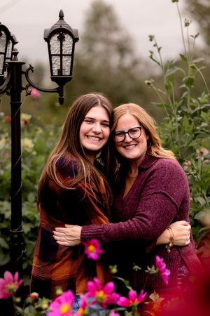 Garden portrait with ornate lamp post and colorful flowers in foreground.