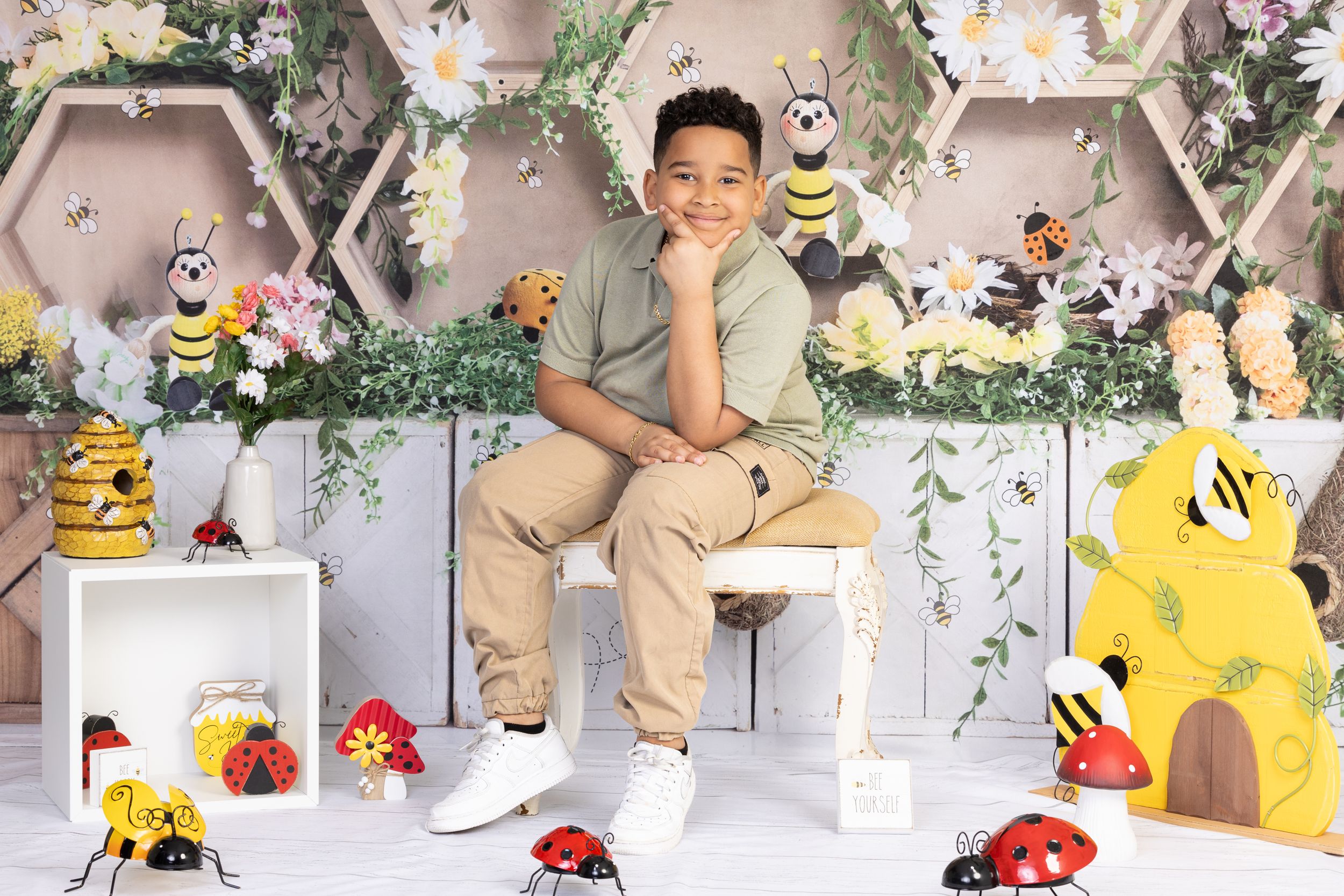 Whimsical honeycomb photo setting with decorative bees, flowers, and ladybugs creating a garden atmosphere.
