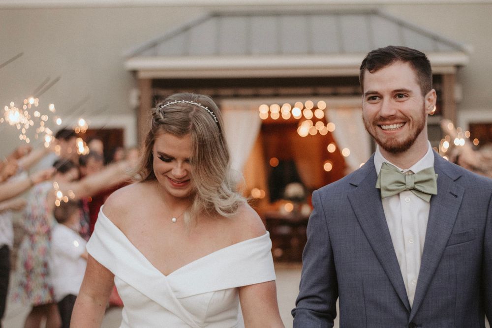 Joyful wedding celebration with string lights and classic formal attire.