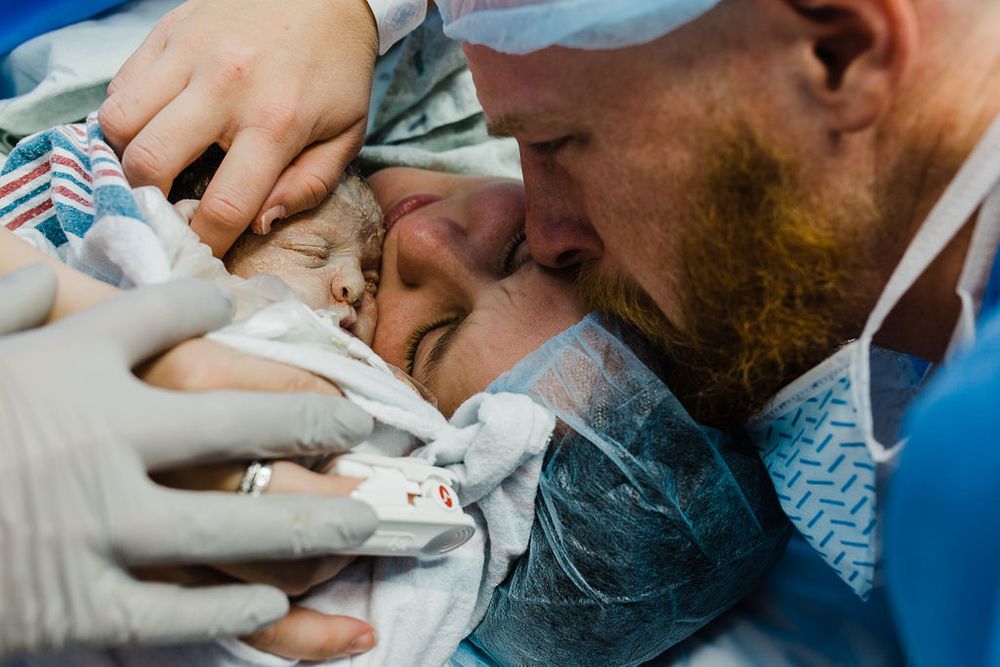 A tender moment in a medical setting during childbirth.