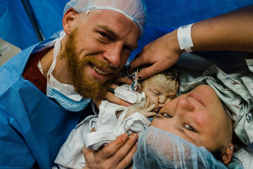Emotional scene in a medical setting with surgical attire.