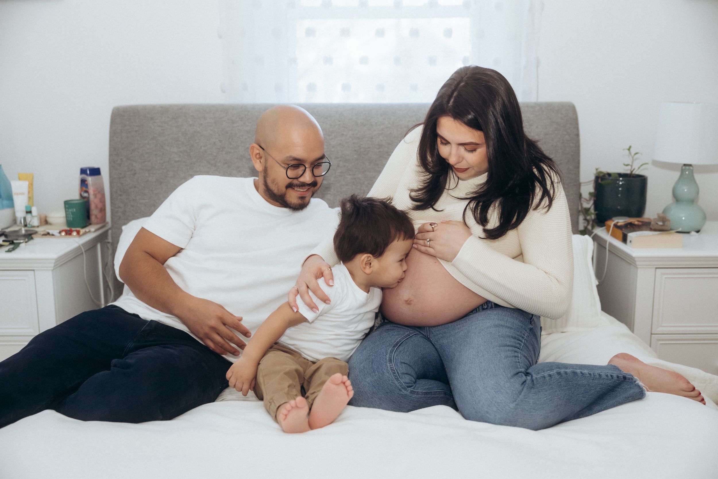 A tender family moment shared on a comfortable bed.