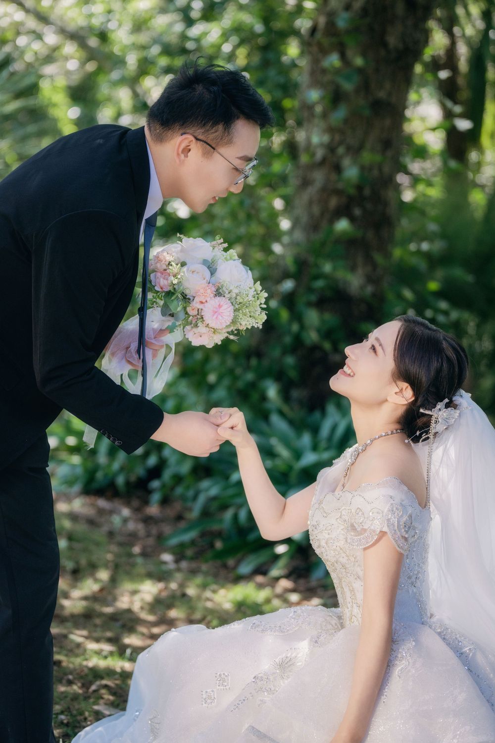 Stunning and happy couple enjoying afternoon sunlight in a natural botanical garden wedding portrait, by Imagine Image Studio Auckland.
