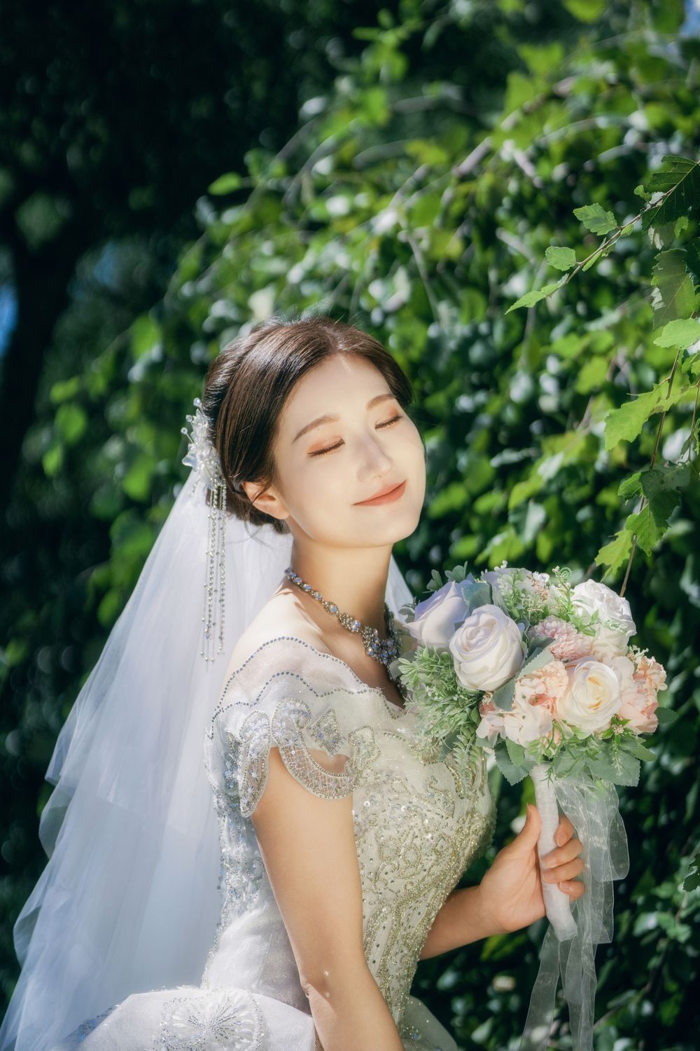 Stunning and happy couple enjoying afternoon sunlight in a natural botanical garden wedding portrait, by Imagine Image Studio Auckland.
