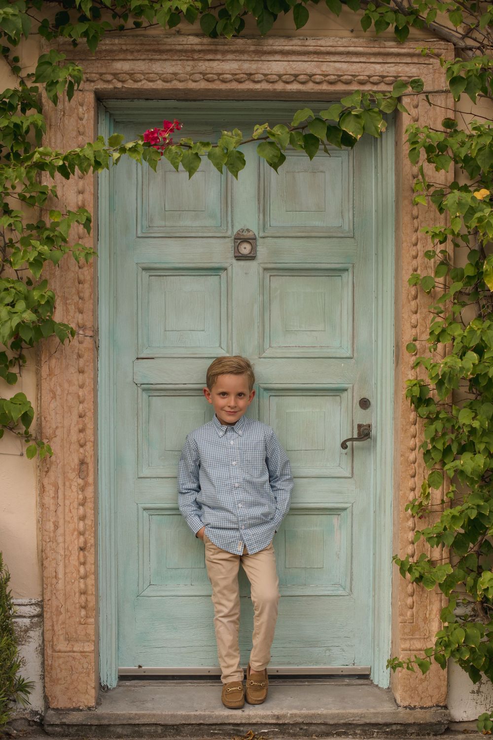 Vintage mint green door with climbing ivy creates charming architectural vignette.