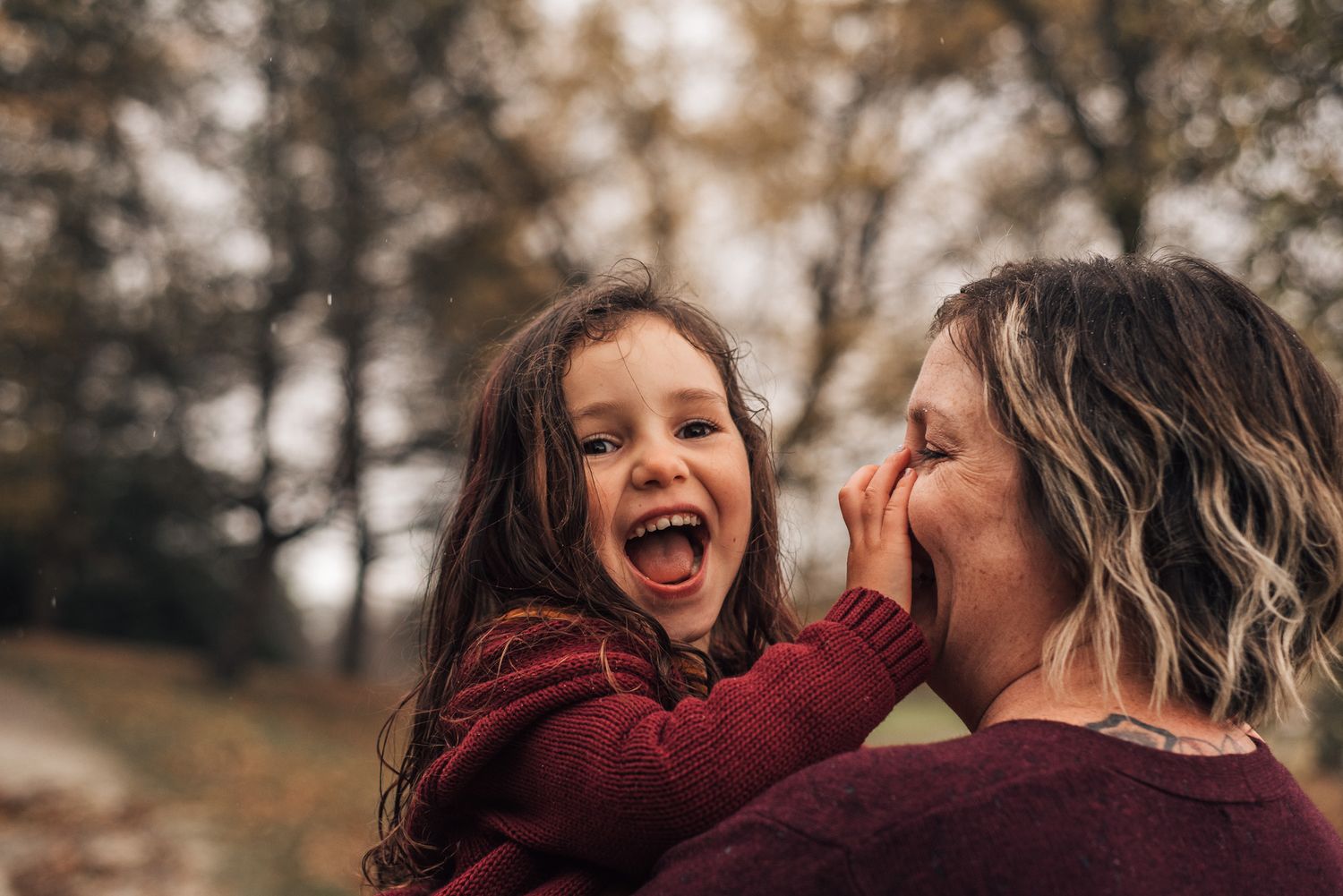 A joyful interaction between two people captured during an autumn day.