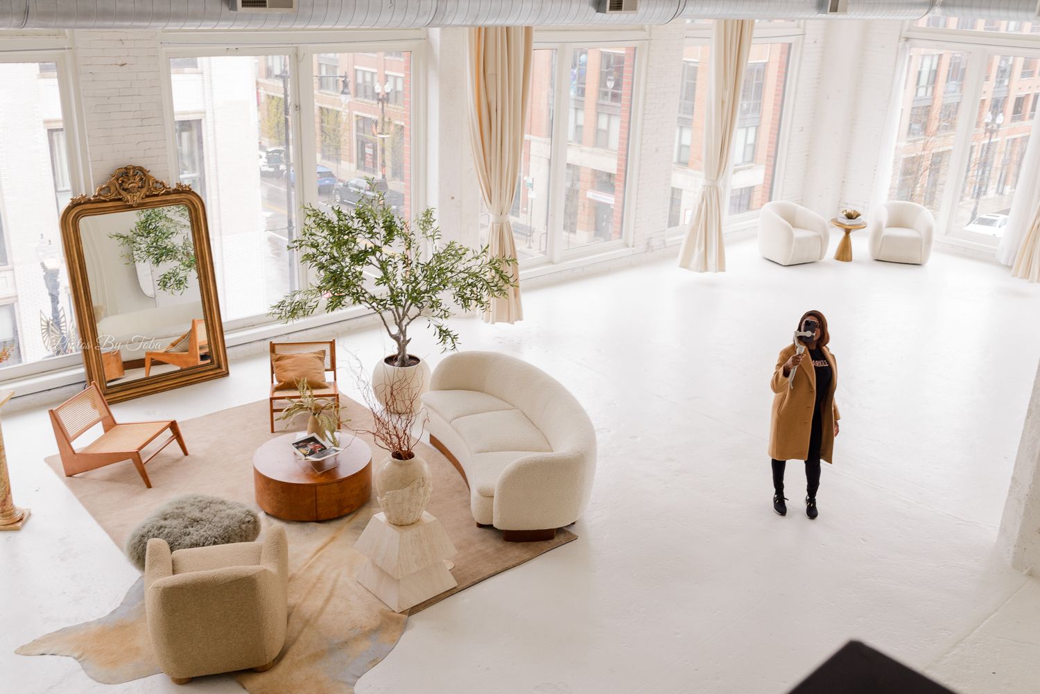 Airy white modern interior design with large windows and contemporary furniture.