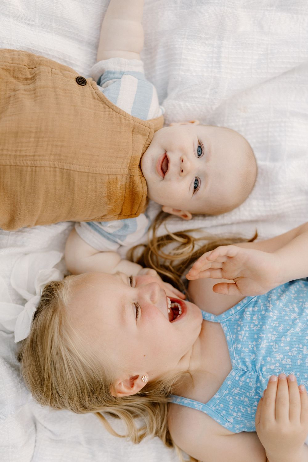 Close up moments of playful interaction between family members while lying down.