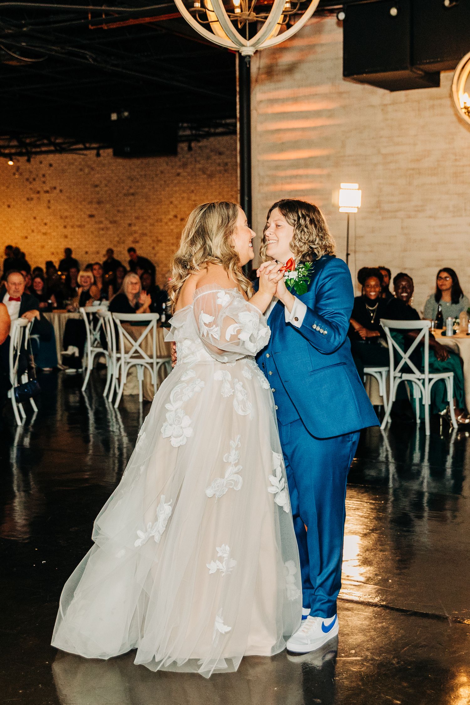 A couple shares an intimate moment on their wedding day in formal attire.