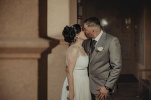 A romantic indoor wedding portrait session with warm lighting and neutral tones.