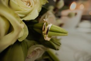 Close-up detail of white roses in a wedding bouquet with soft bokeh effect.