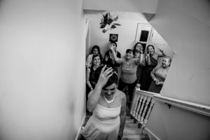 Series of monochrome images showing wedding day reactions and emotions in a hallway.