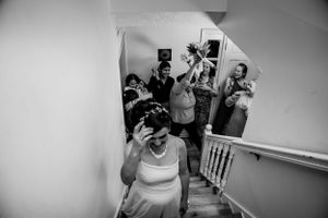 Black and white wedding photos capturing candid reactions in an indoor setting.