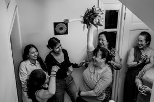 Candid black and white photos showing emotional reactions during a wedding event.