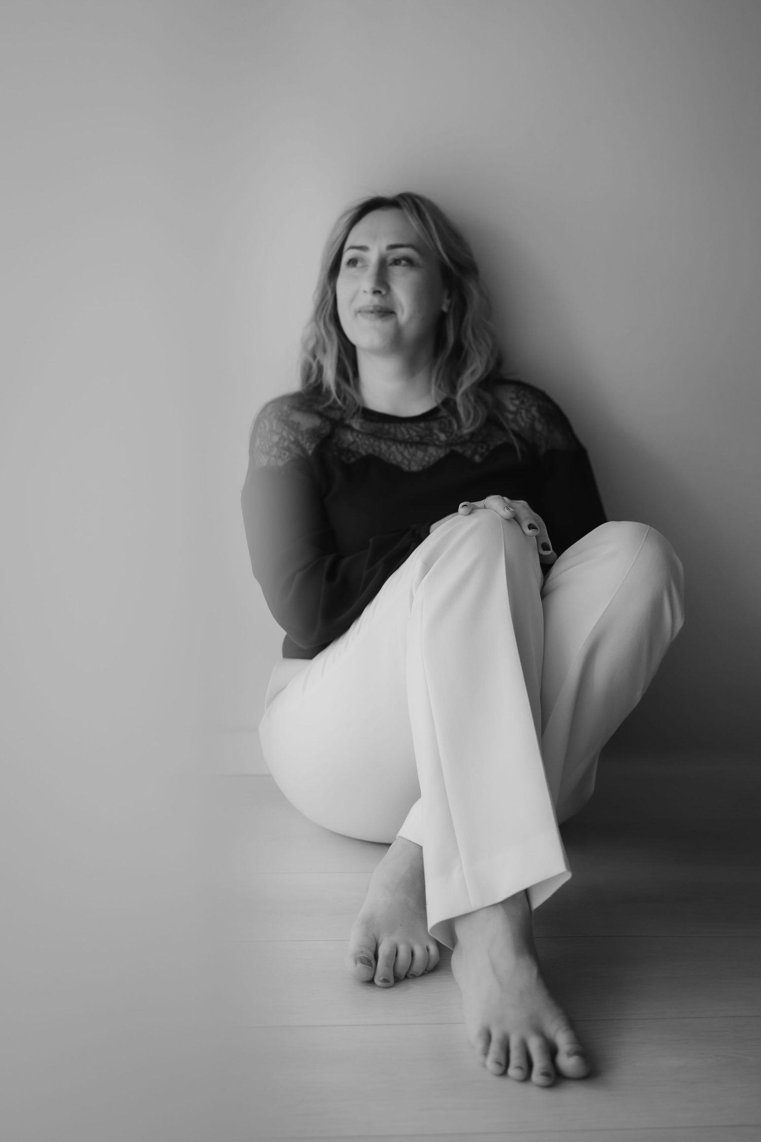 A series of black and white artistic portraits showing dramatic poses and movements against minimalist backgrounds.