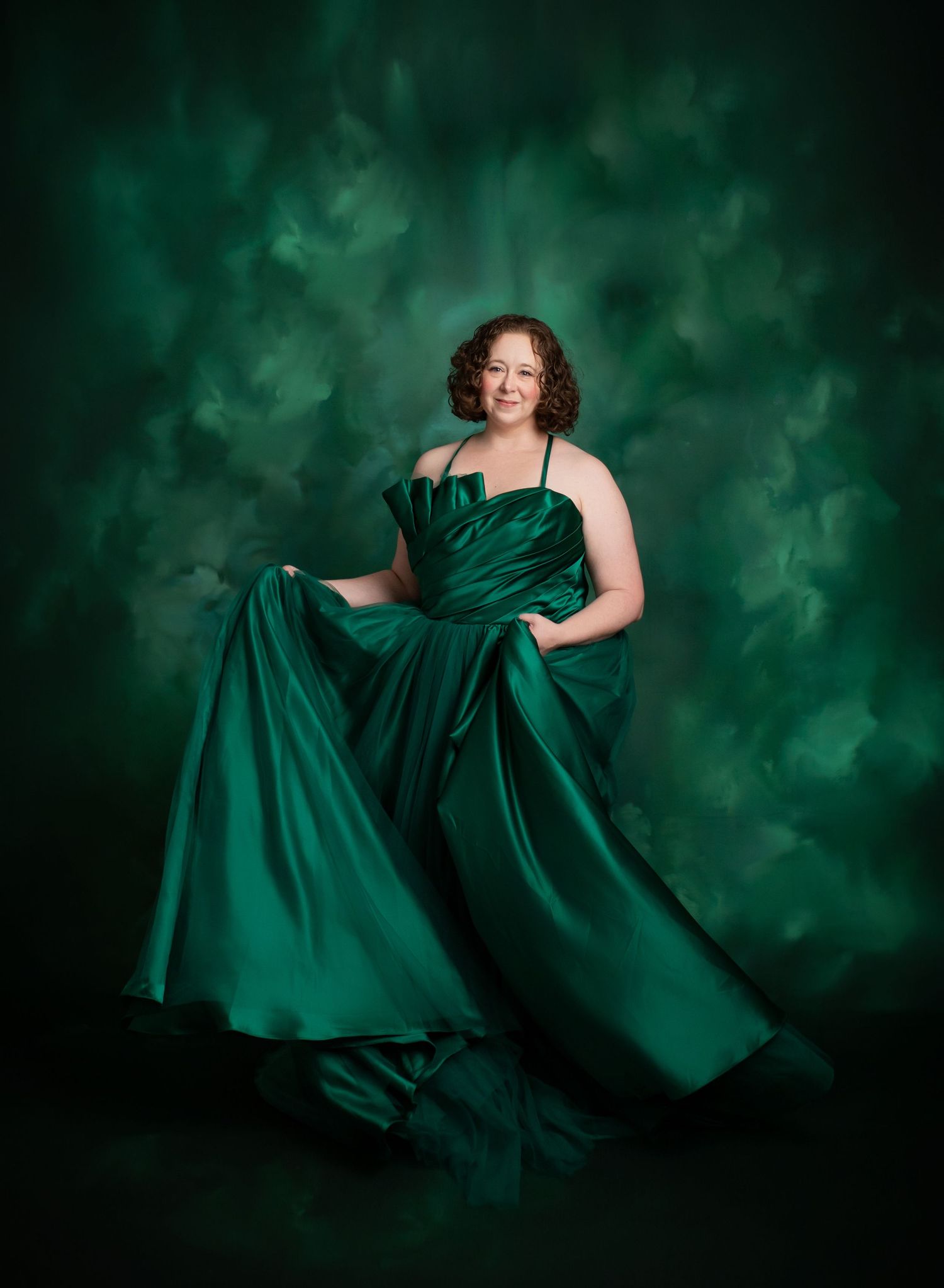 A emerald green party dress twirling against a dark background with flowing green light effects.