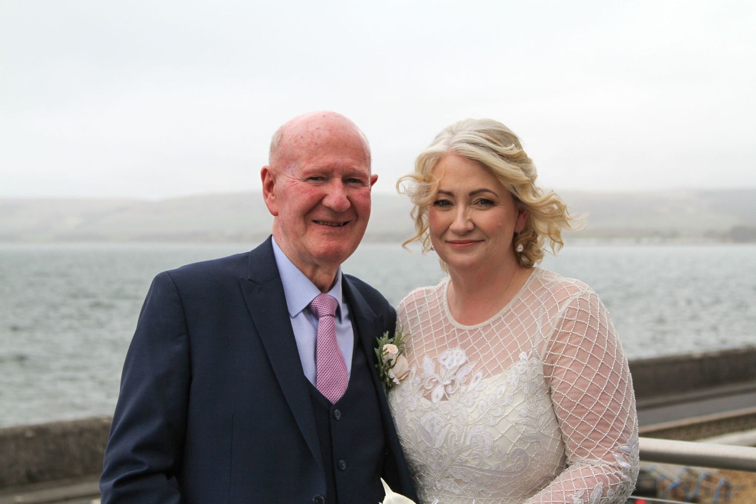 Wedding portraits by the seaside with elegant formal attire.