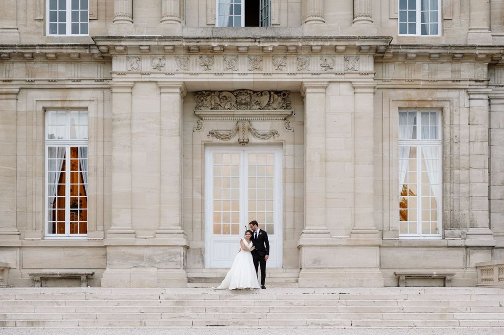 Elegant stone facade of a classical building with symmetrical windows.