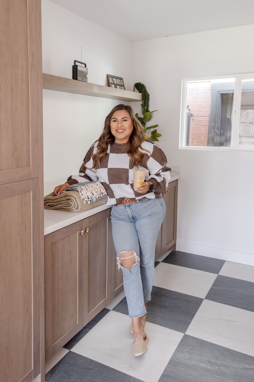 Bright casual interior with checkered floor and built-in storage cabinets.