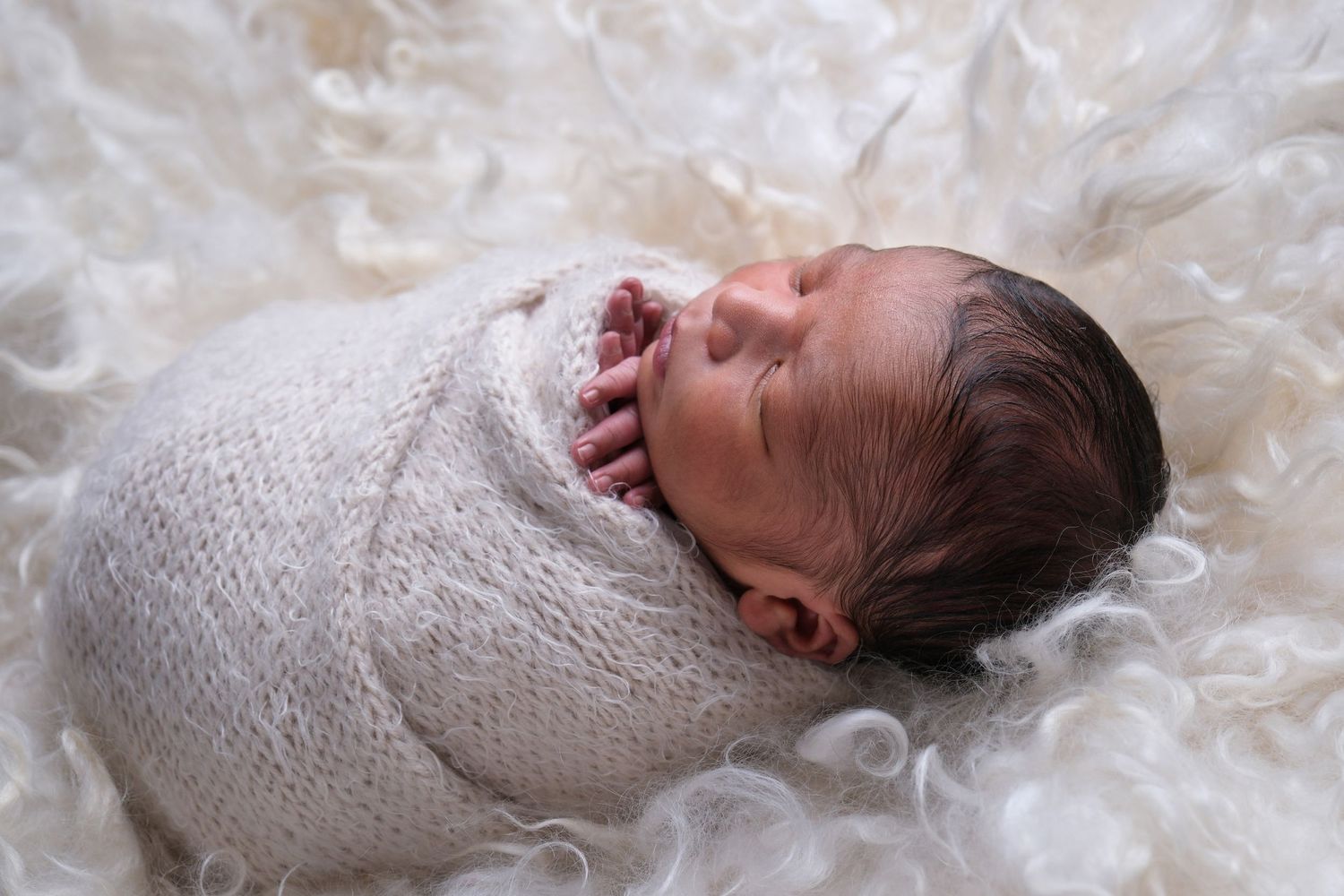 Newborn baby wrapped during newborn photography session